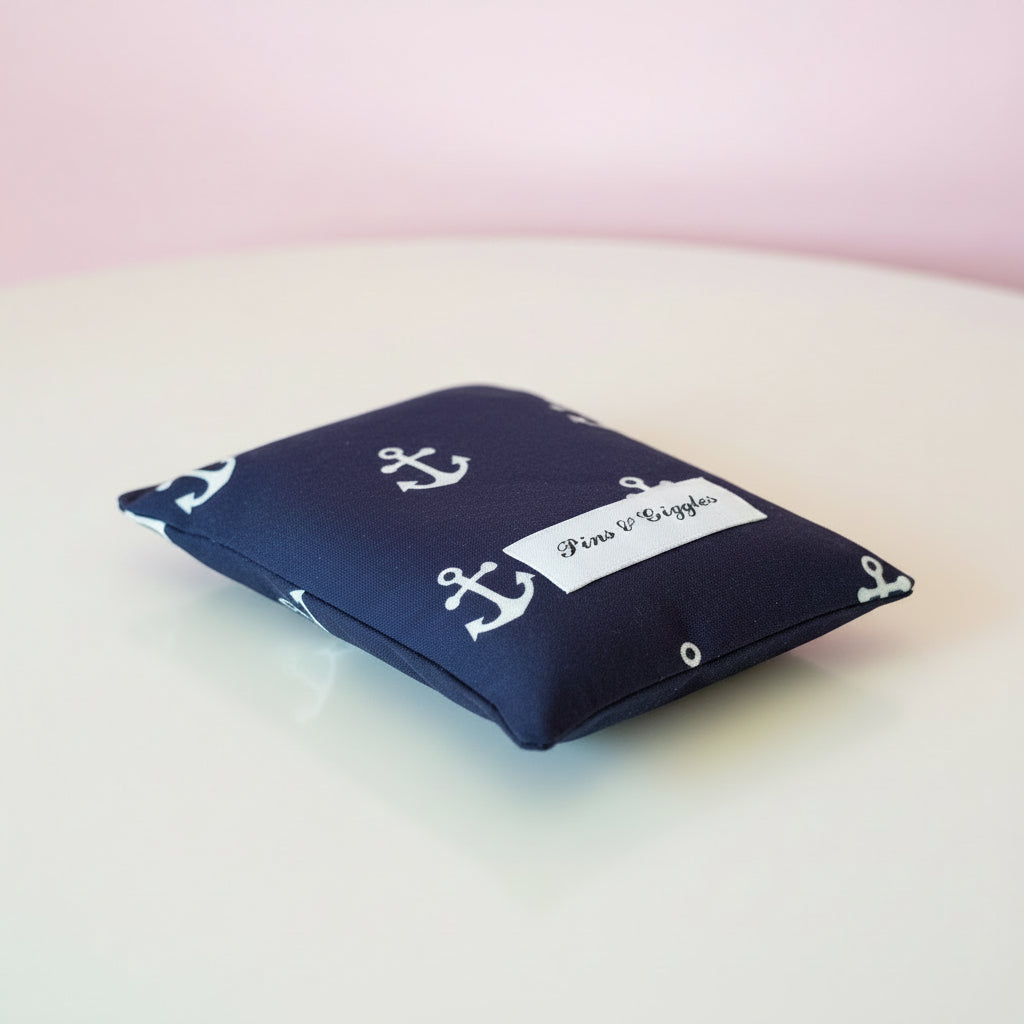 Navy pouch with white anchor pattern on a white surface