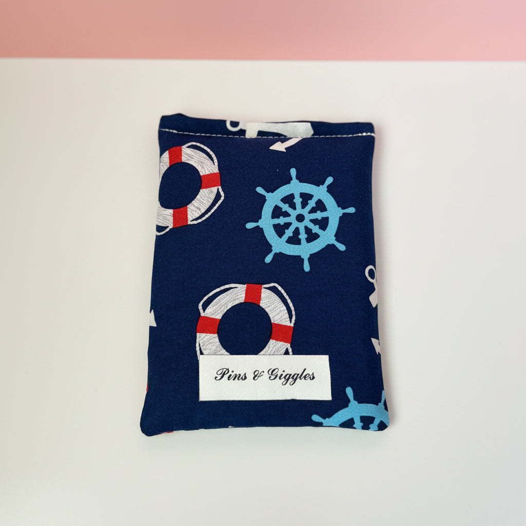Navy blue pouch with nautical patterns on a white surface