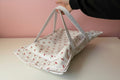 casserole carrier with long white straps and cherry pattern