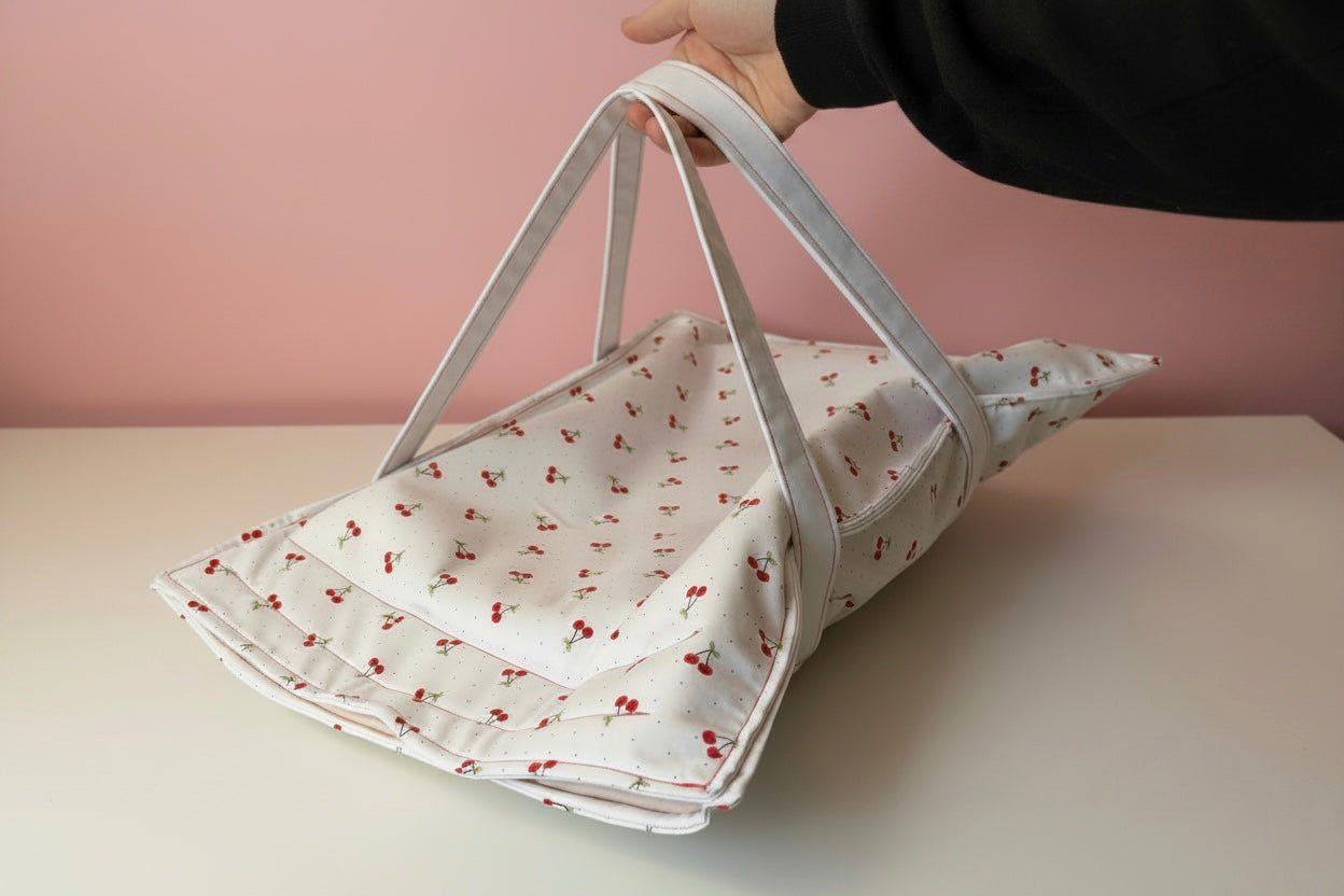 casserole carrier with long white straps and cherry pattern
