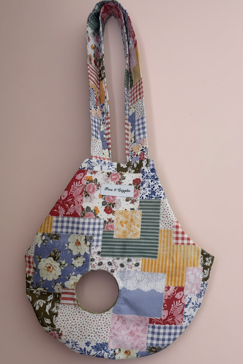 Patchwork-style chicken carrier sling with floral and patchwork patterns on a beige background