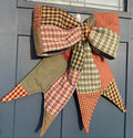 Decorative plaid bow on a blue door