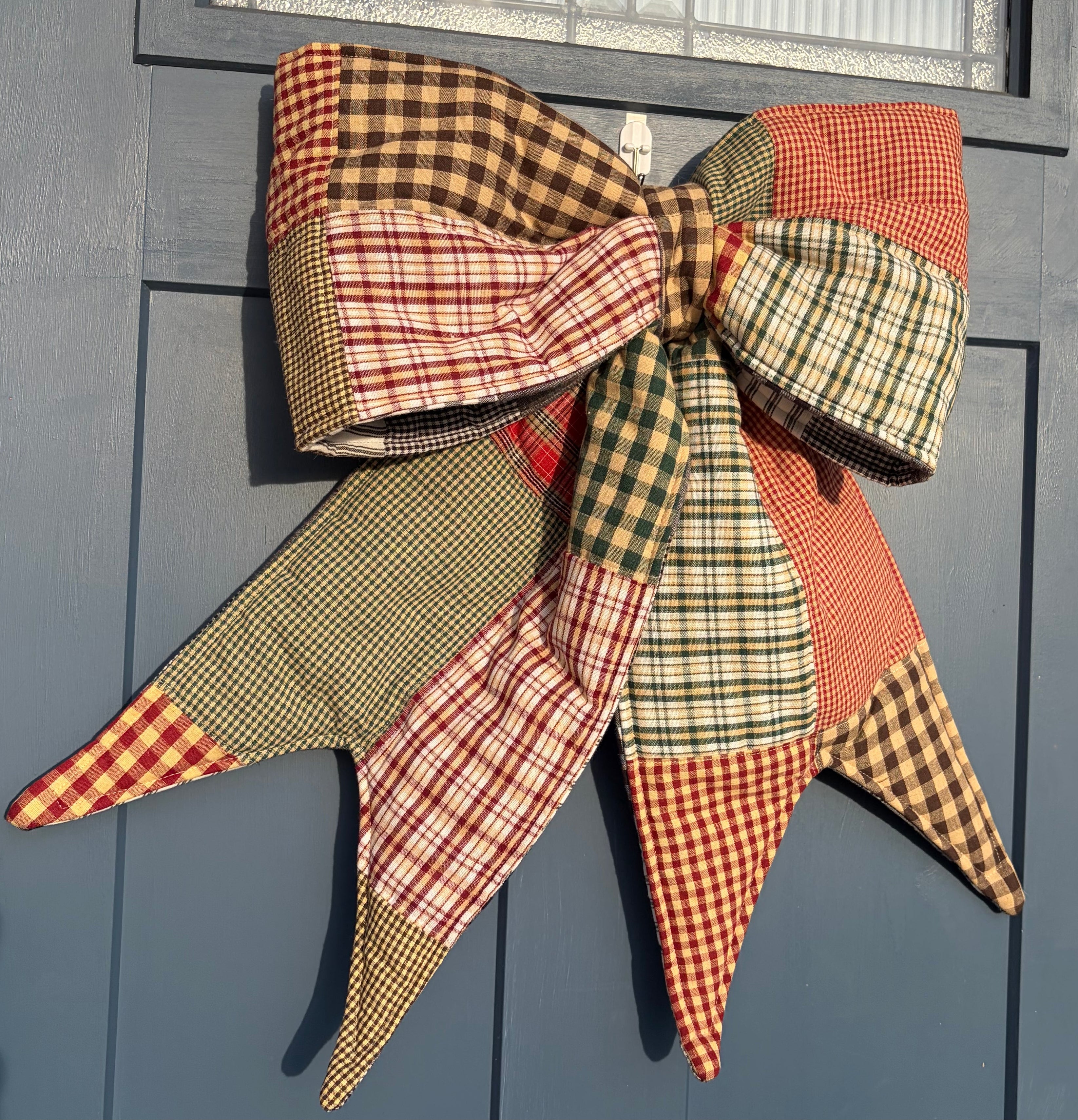 Decorative plaid bow on a blue door