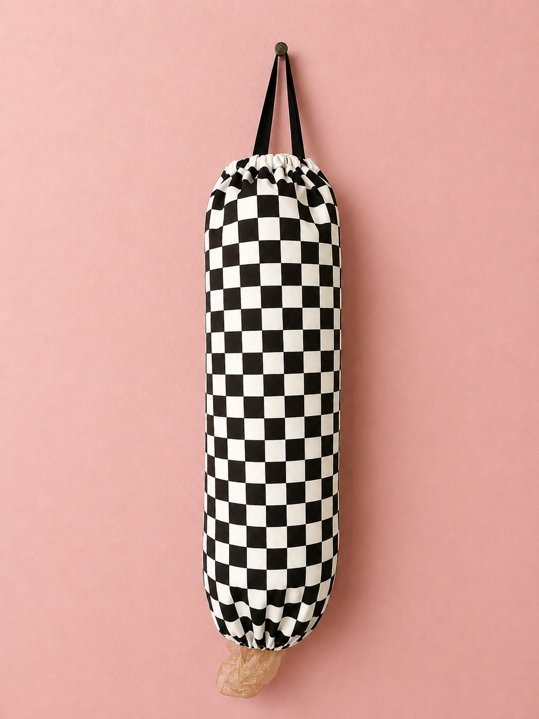 Long black and white checkered fabric bag on a pink background