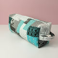 Hair tool bag with blue and grey patchwork fabric.