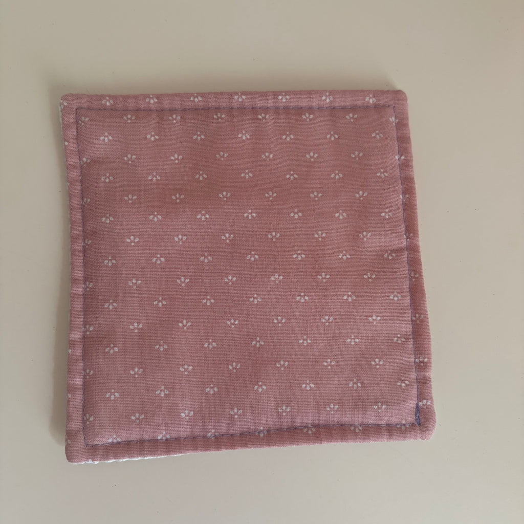 pink fabric jar gripper with a subtle pattern on a white background