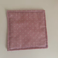 pink fabric jar gripper with a subtle pattern on a white background