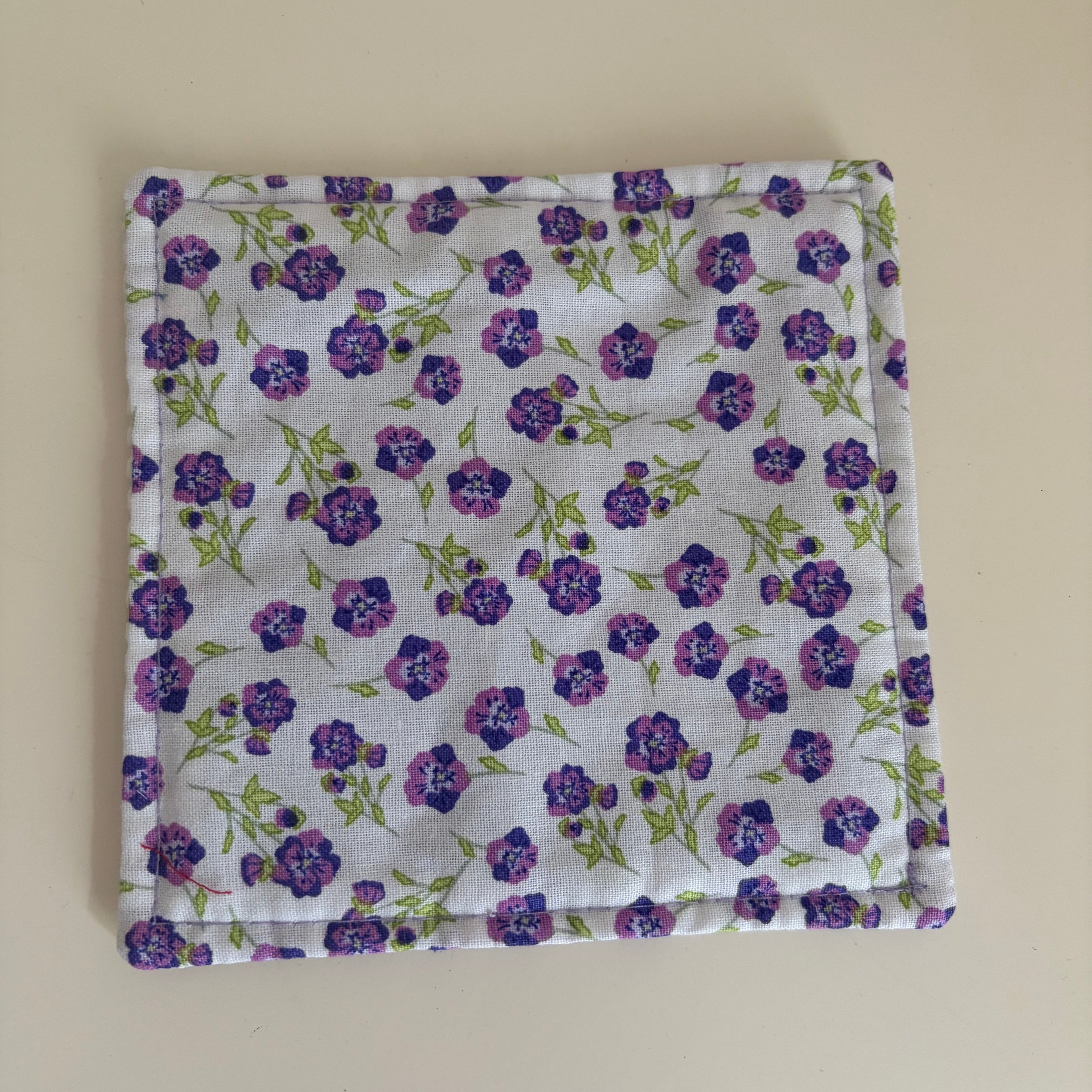 Floral patterned fabric jar gripper on a white background