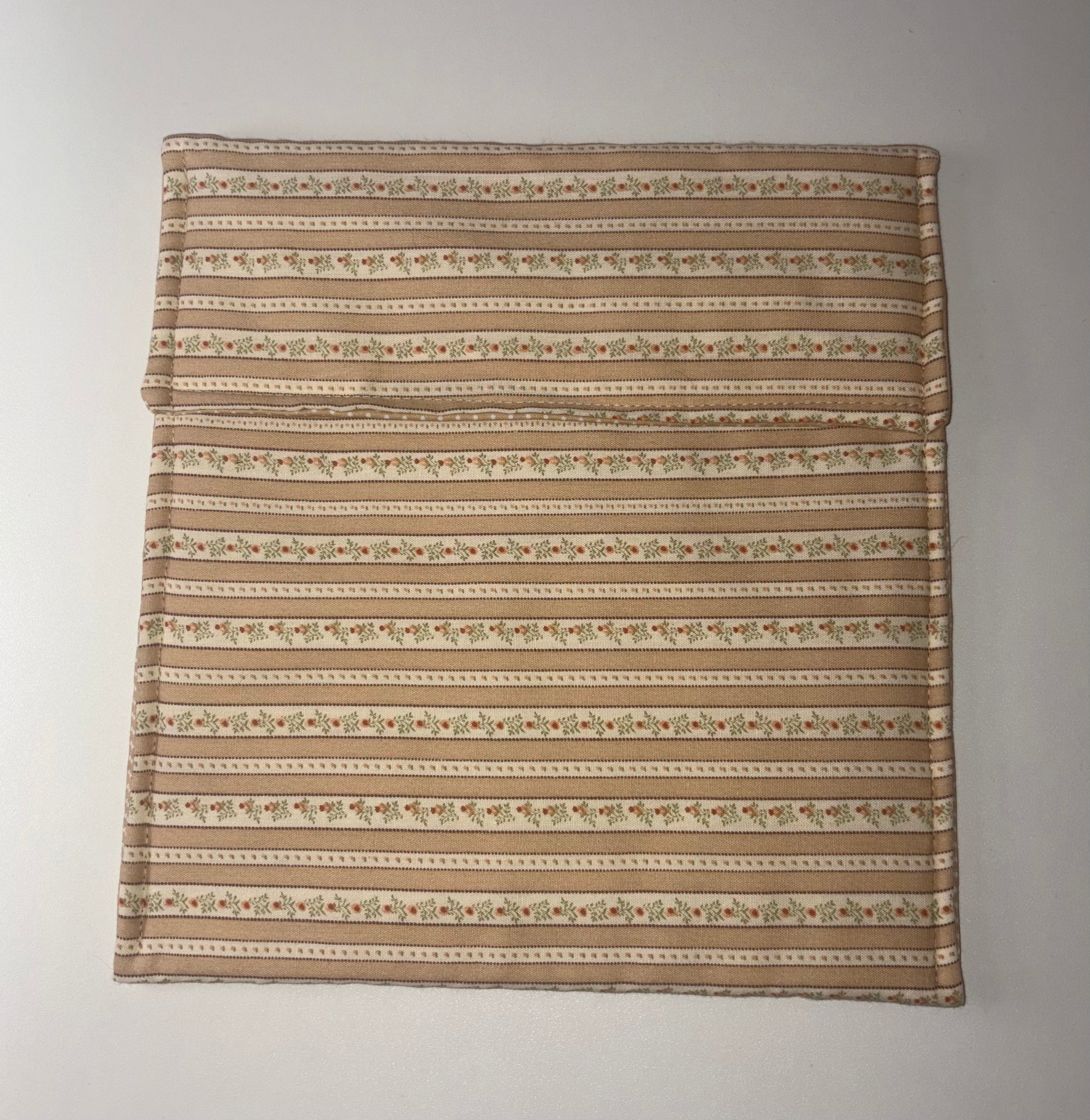 Striped flat fabric pouch with a subtle pattern on a plain background