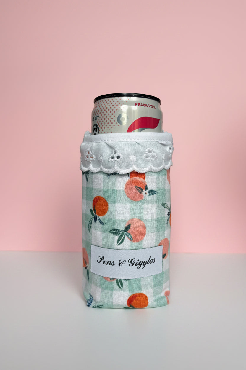 Can cooler with peach pattern on a pink background
