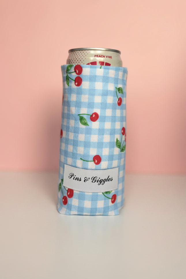 Can cooler with cherry design on a white surface