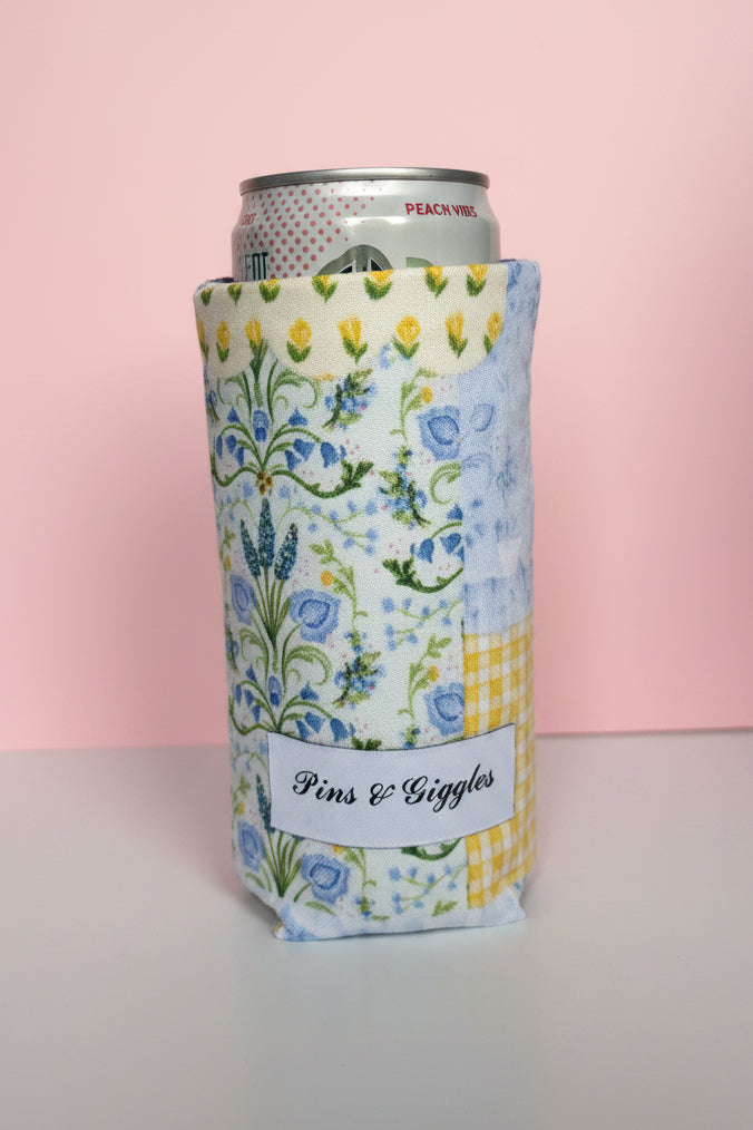 Floral patterned can cooler with a pink background
