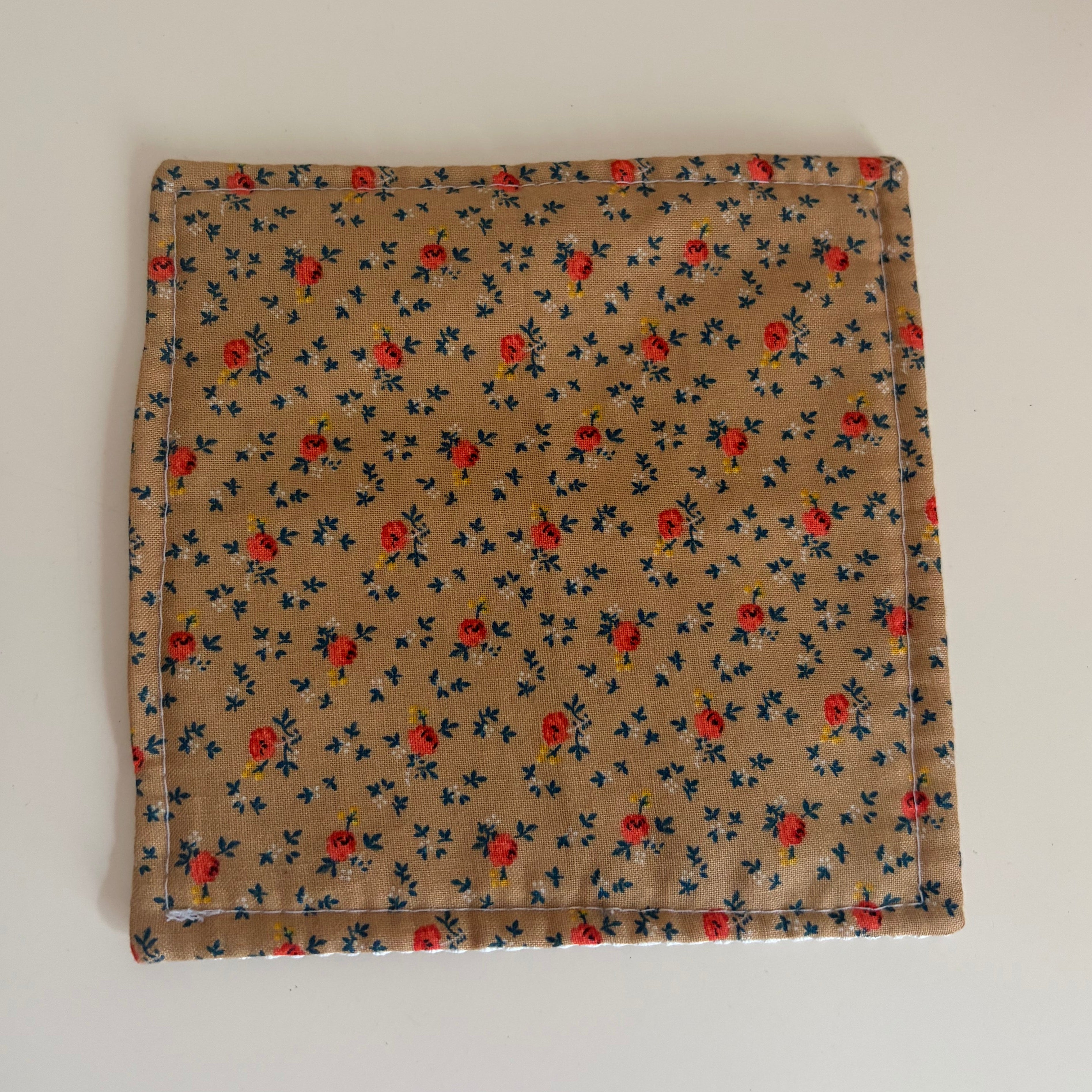 Floral patterned fabric jar gripper on a white background