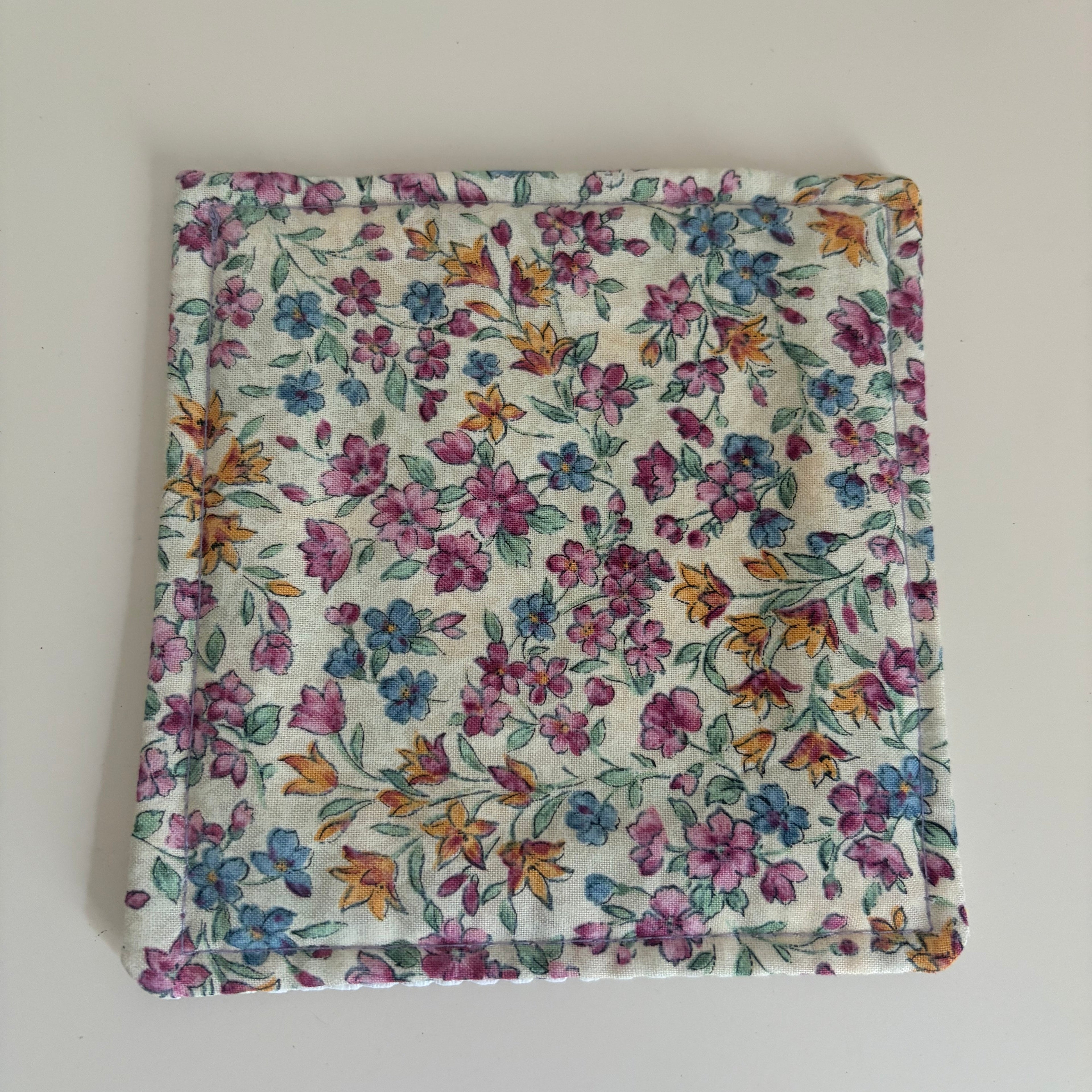 Floral patterned fabric jar gripper on a white background