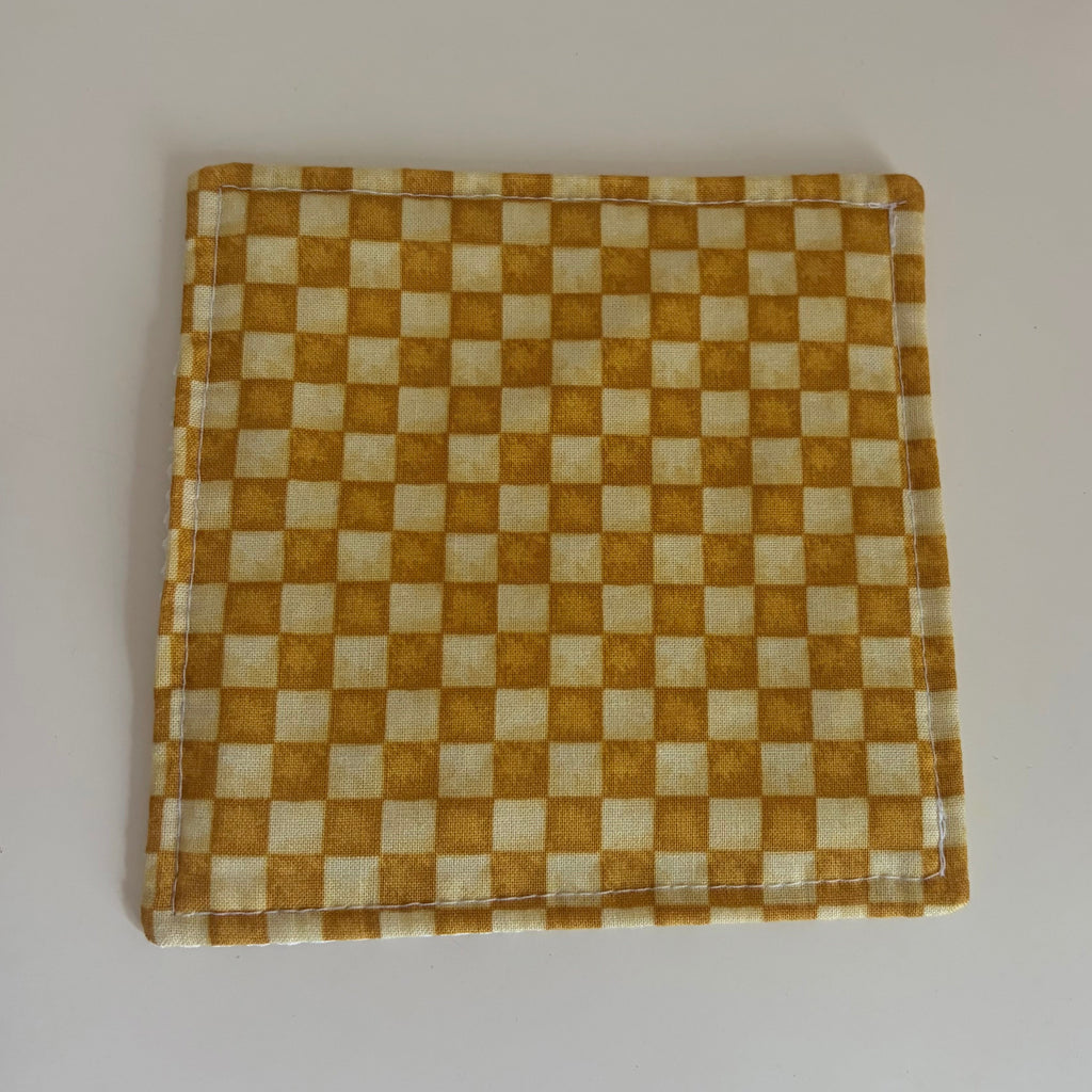 Checkered fabric jar gripper on a white surface