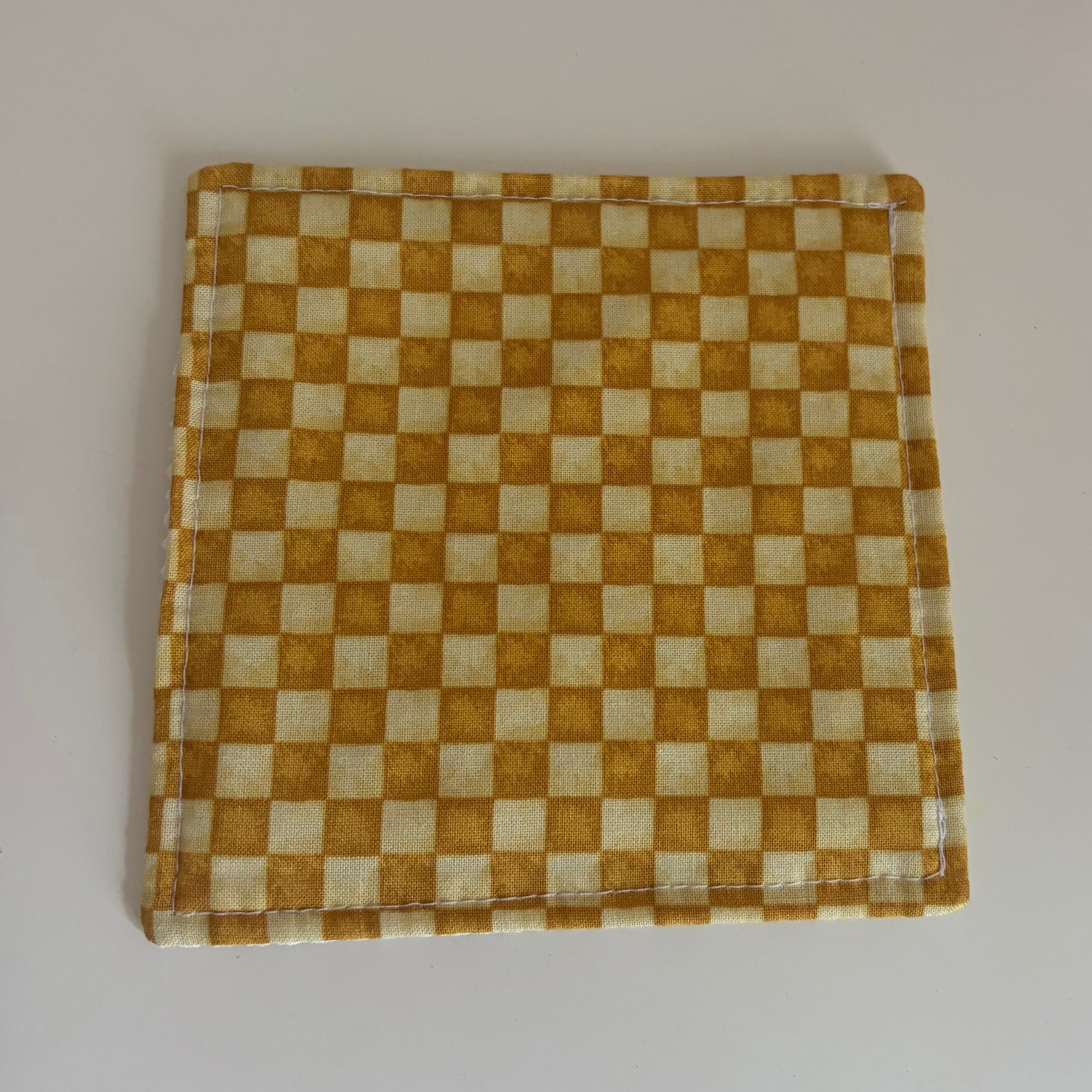 Checkered fabric jar gripper on a white surface