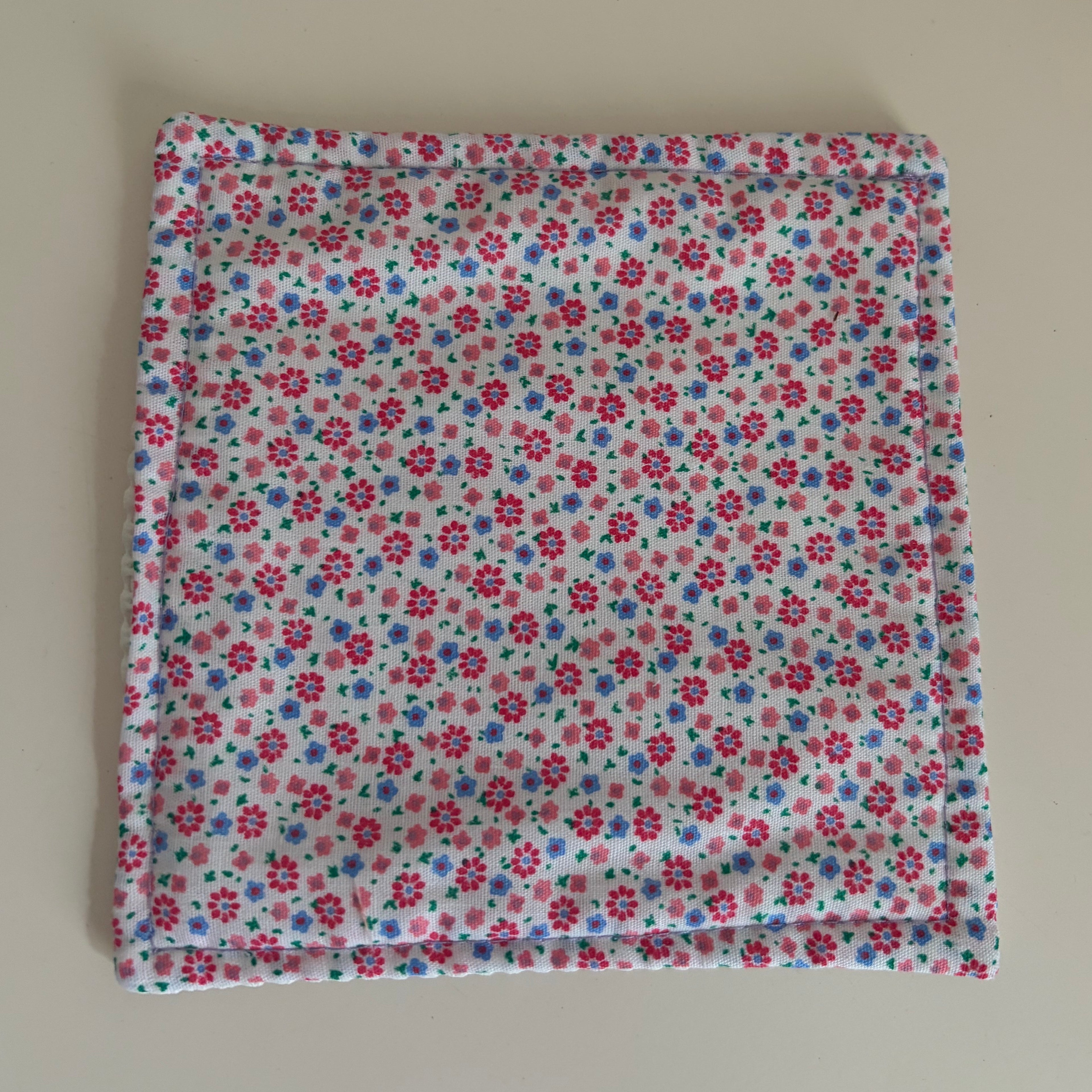 Floral patterned fabric jar gripper on a white background