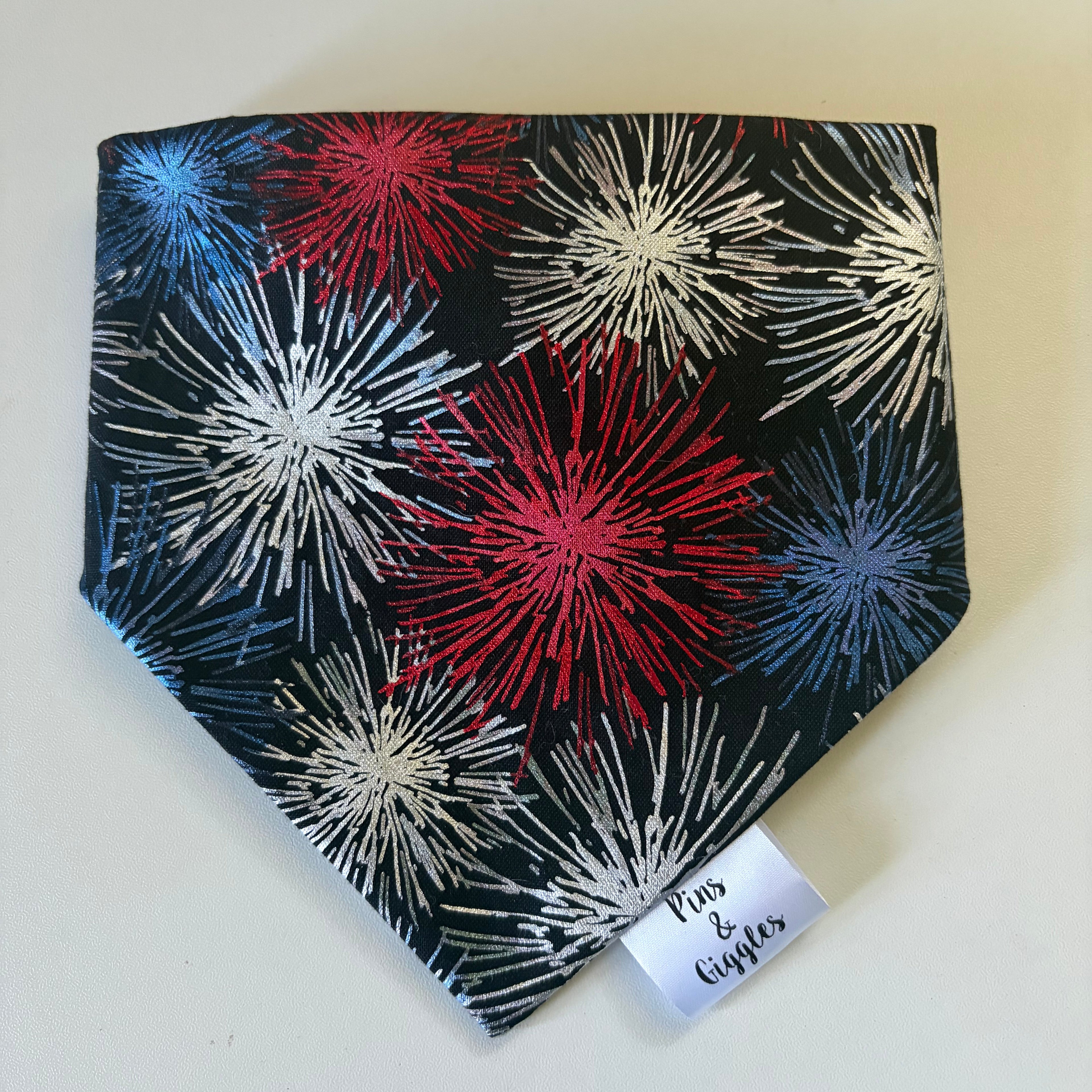 Dog bandana with red, white, and blue firework pattern on a light background