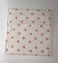 Flat Fabric pouch with cherry pattern on a plain background