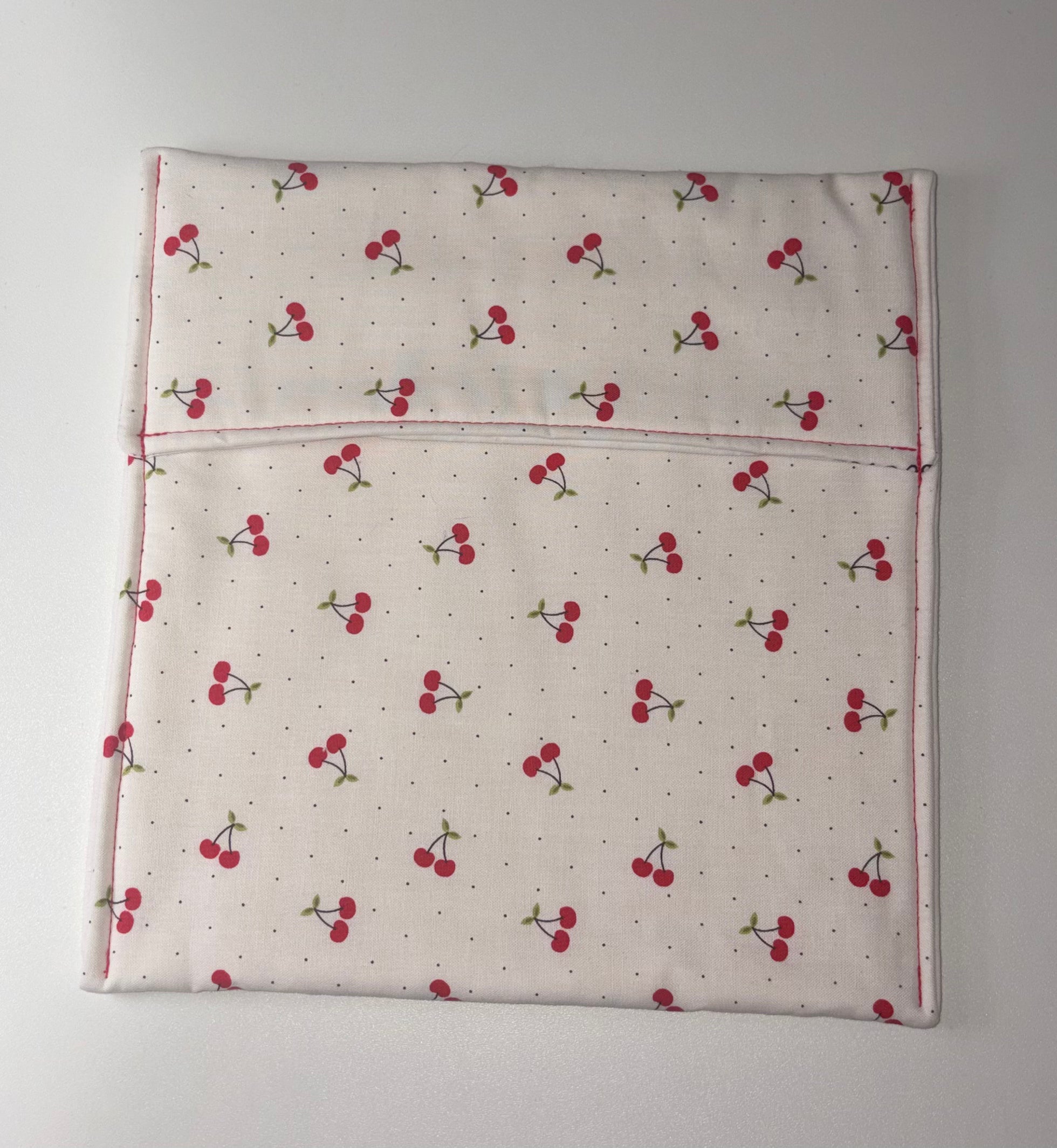 Flat Fabric pouch with cherry pattern on a plain background