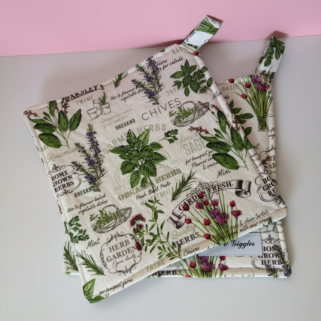 Set of two pot holders with herb-themed design on a wooden surface.