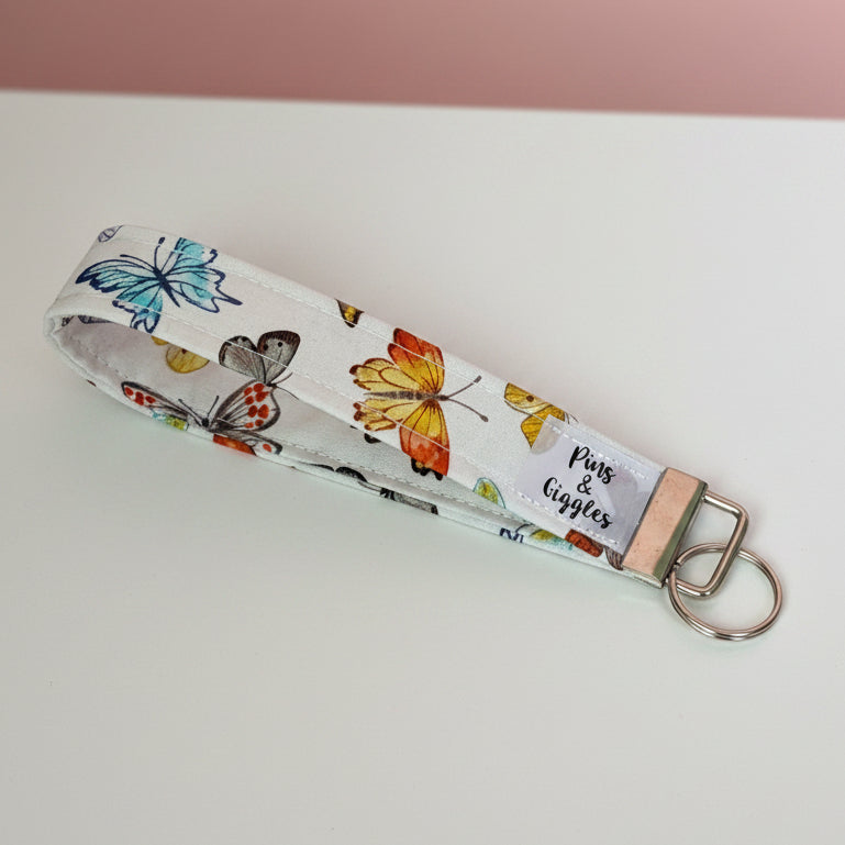 Keychain with butterfly design on a white surface