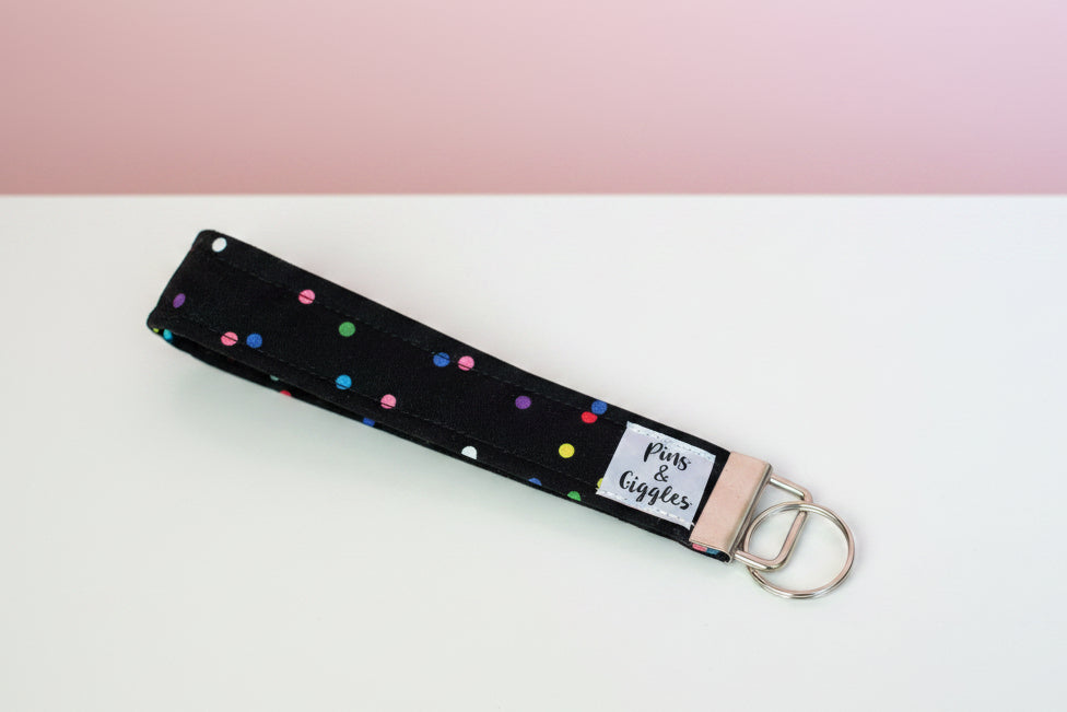 Keychain with colorful polka dots on a white surface
