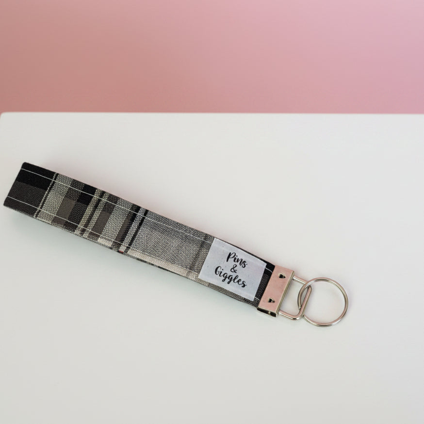 Keychain with tartan pattern on a white surface